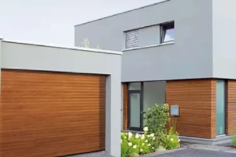 Black 77mm roller garage door installed on a wider opening