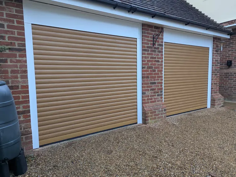 Ivory 77mm insulated electric roller garage door fitted to a double garage