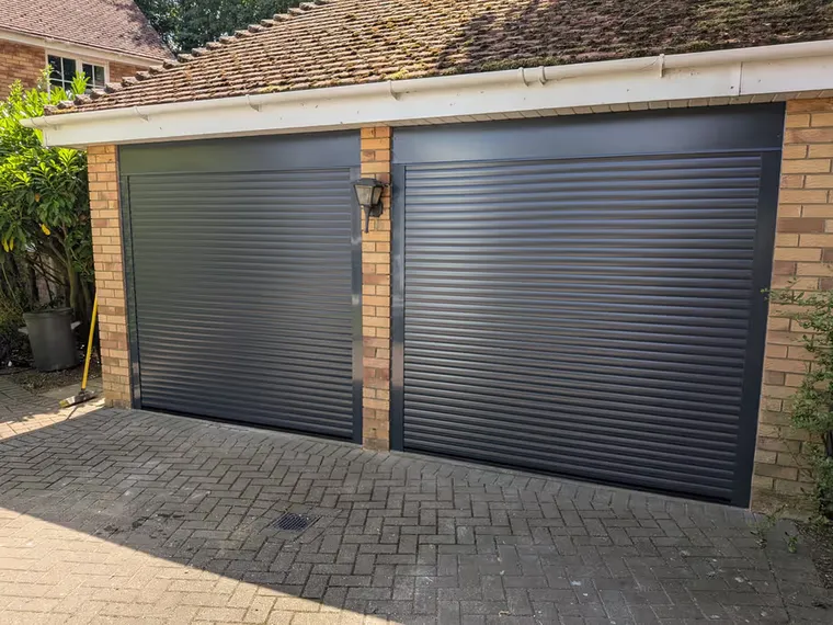 Anthracite grey insulated roller garage door installed by Rollrite on a double garage